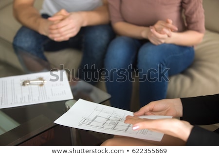 Stok fotoğraf: Realtor Showing Blueprint Of New Home To Couple