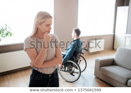 Stockfoto: Invalid Or Disabled Woman Sitting Wheelchair Looking Window Daylight