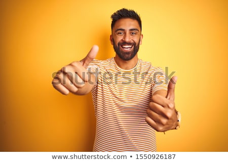 [[stock_photo]]: Happy Indian Man In T Shirt Showing Ok Hand Sign