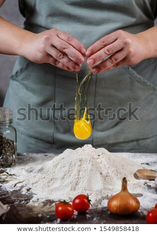 Stock photo: Female Housewife Making Homemade Pasta With Flour And Eggs Over