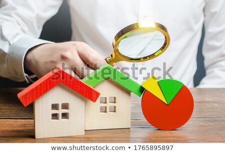 Foto d'archivio: Man Is Studying The Structure Of Housing Costs With A Magnifying Glass Revision Of Utility Bills An