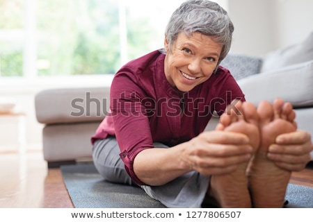 ストックフォト: Woman Doing Toes Stretching Yoga Exercise