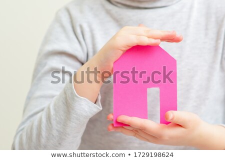 Foto stock: Closeup Portrait Of Little Caucasian Girl Holding House Building