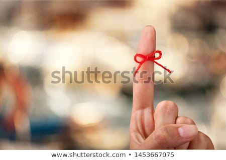 [[stock_photo]]: Red Bow On Finger