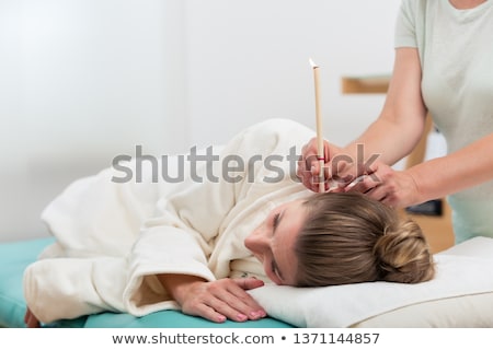 Woman In Therapy With Ear Candles Stockfoto © Kzenon
