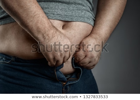 Zdjęcia stock: Man Trying To Fasten Pants