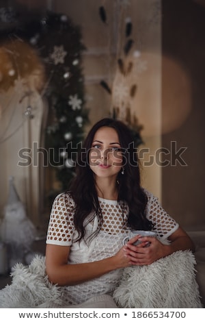 Foto stock: Happy Woman Holding A Cup Of Coffee Wearing Pajamas