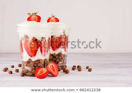 ストックフォト: Colorful Breakfast With Chocolate Balls Corn Flakes Sliced Strawberry Leaves Mint In Jars On White