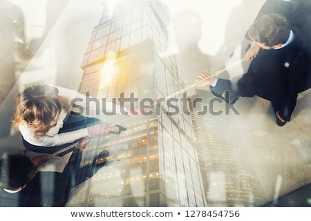 Stock foto: Rival Business Man And Woman Compete For The Command By Pulling The Rope Double Exposure
