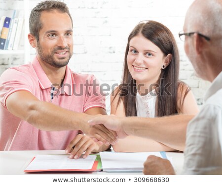 Foto d'archivio: Young Man Shaking Hands With An Insurance Agent Or Investment Ad