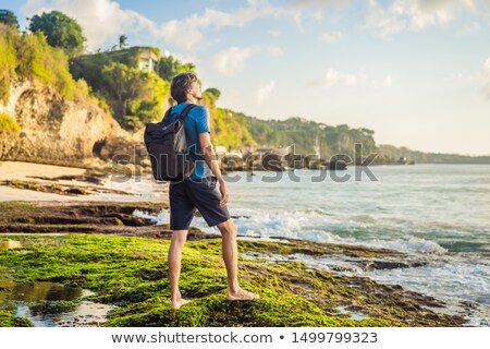 Stock fotó: Young Man Tourist On Pantai Tegal Wangi Beach Bali Island Indonesia Bali Travel Concept