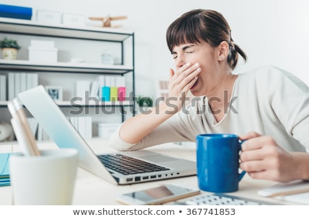 Stock fotó: Woman Yawning At A Desk