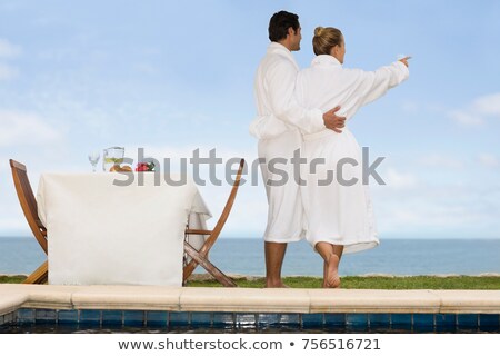 Foto stock: Couple In Bathrobes Watching The Sea