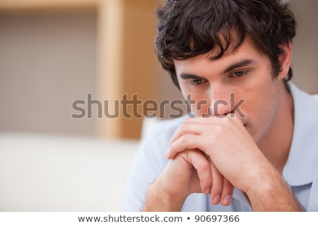 Foto stock: Thoughtful Young Man In The Living Room