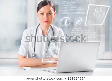 Foto stock: Doctor With Hightech Computer Screen Viewing Patient Data