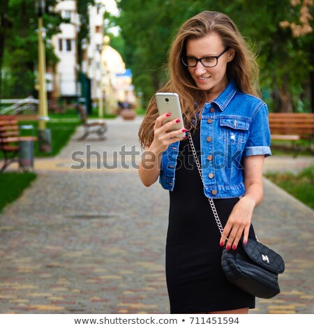 Stock fotó: Young Girl In Black Dress Writing A Short Message