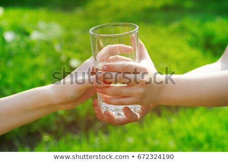 Zdjęcia stock: Thirsty Man Drinks Out Of A Glass In The Outdoor Garden
