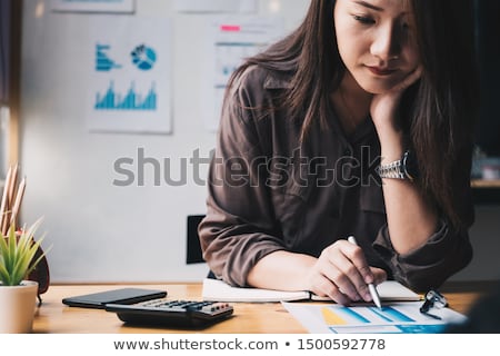 Stock fotó: Woman With Calculator Doing Finances