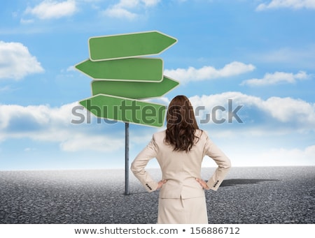 Сток-фото: Thoughtful Businesswoman And Road Sign