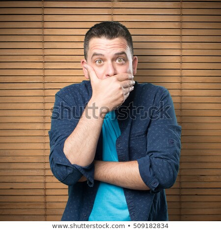 Сток-фото: Face Of Man Covering His Mouth With Hand Palm