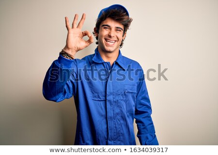 Stok fotoğraf: Smiling Mechanic Showing Ok Sign