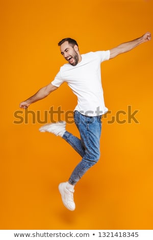 Stock fotó: Full Length Portrait Of A Casual Attractive Man Jumping