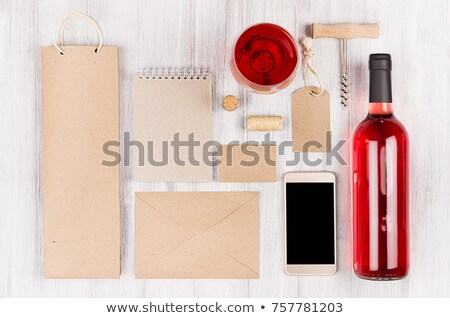 Stock fotó: Corporate Identity Template For Wine Industry With Bottle Rose Wine And Wineglass On Soft White Wood