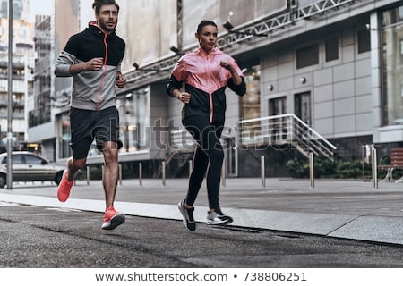 Сток-фото: Couple In Sports Clothes Running Outdoors