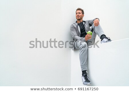 Healthy Sport Man Drinking Green Smoothie During Training At Gym In Activewear Sweatpants Outdoor A Stockfoto © Maridav