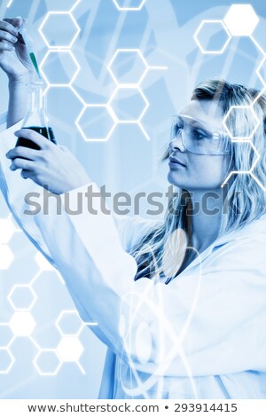 Stok fotoğraf: Woman In Lapcoat Looking At Chemicals