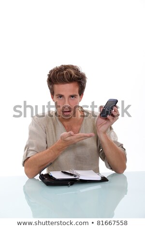 Stock foto: Man With A Personal Organizer Demonstrating Cellphone
