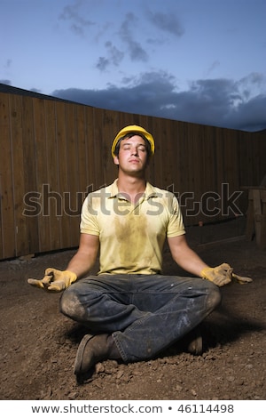 Construction Worker In A Yoga Pose Imagine de stoc © iofoto