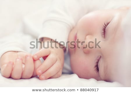 Foto stock: Close Up Of A Baby Boy Lying On The Bed