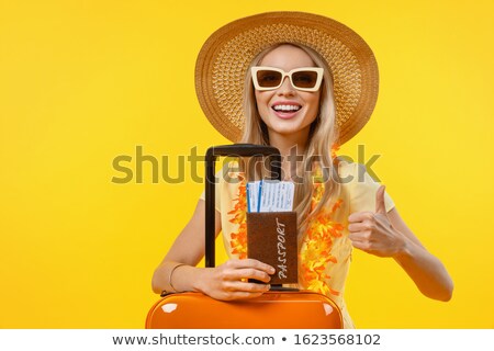 Stockfoto: Young Woman With A Thumb Up And Yellow Suitcase Is Traveling On