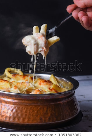 [[stock_photo]]: Tasty Seafood In White Sauce On A Metal Black Plate