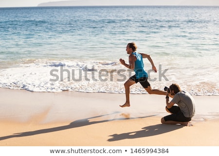 [[stock_photo]]: Behind The Scenes Of Photo Shoot Of Male Sports Athlete Model Running For Photographer Taking Pictur