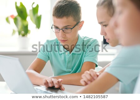 Two Schoolboys Concentrating On Schoolwork While Sitting In Front Of Laptop Сток-фото © Pressmaster