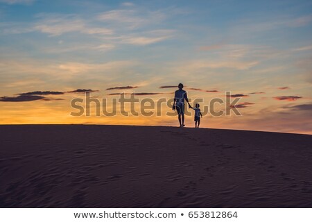 Zdjęcia stock: Father And Son At The Red Desert At Dawn Traveling With Children Concept