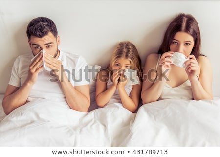 Foto stock: Family With Ill Children Having Fever At Home