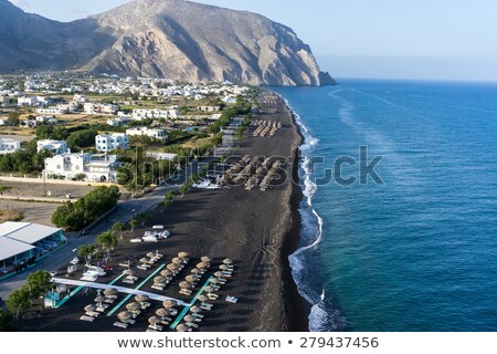 [[stock_photo]]: Sunbeds In Perissa Santorini Greece