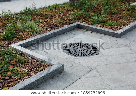 Stock photo: Paving Stones With Metal Manhole