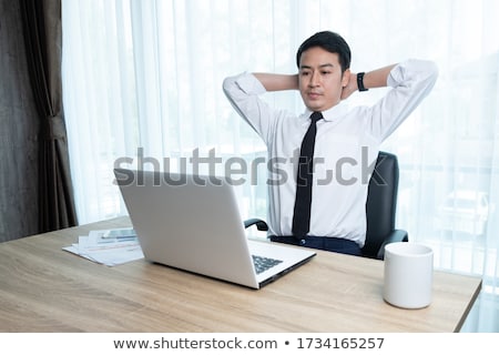 Stockfoto: Business Man Resting His Arm On A White Modern Table