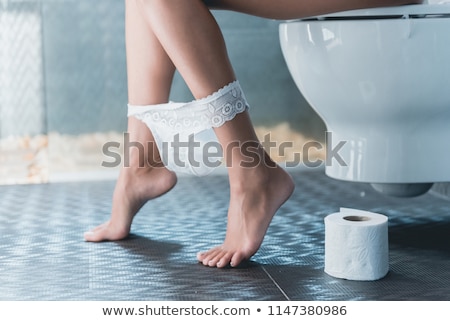 Stock foto: Woman Panties On Legs In Toilet