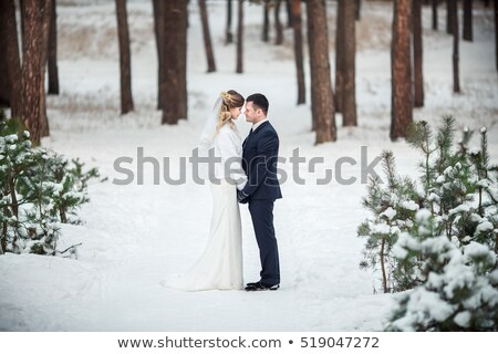 Foto stock: Young Funny Couple Having Fun In Snowy Forest