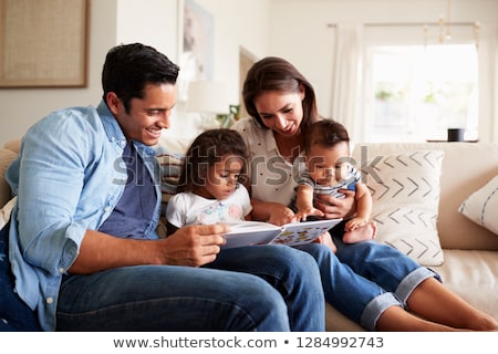 Stok fotoğraf: Three Girls Reading Books In Living Room