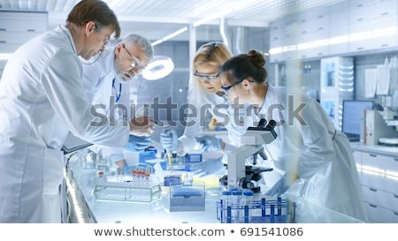 Foto stock: Busy Medical Scientist Working In Laboratory