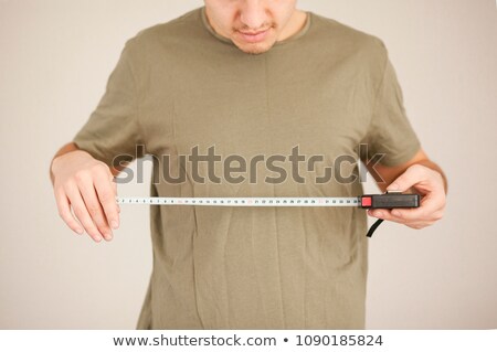 [[stock_photo]]: Man Measuring Width Of Wall