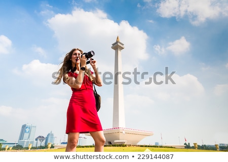 Сток-фото: Tourist With Camera Sightseeing At Monumen Nasional