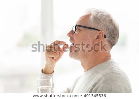 Stock photo: Medicine Pills In Glass Of Water