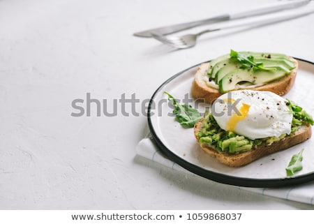 Stock fotó: Toasts With Avocado And Poached Eggs Background